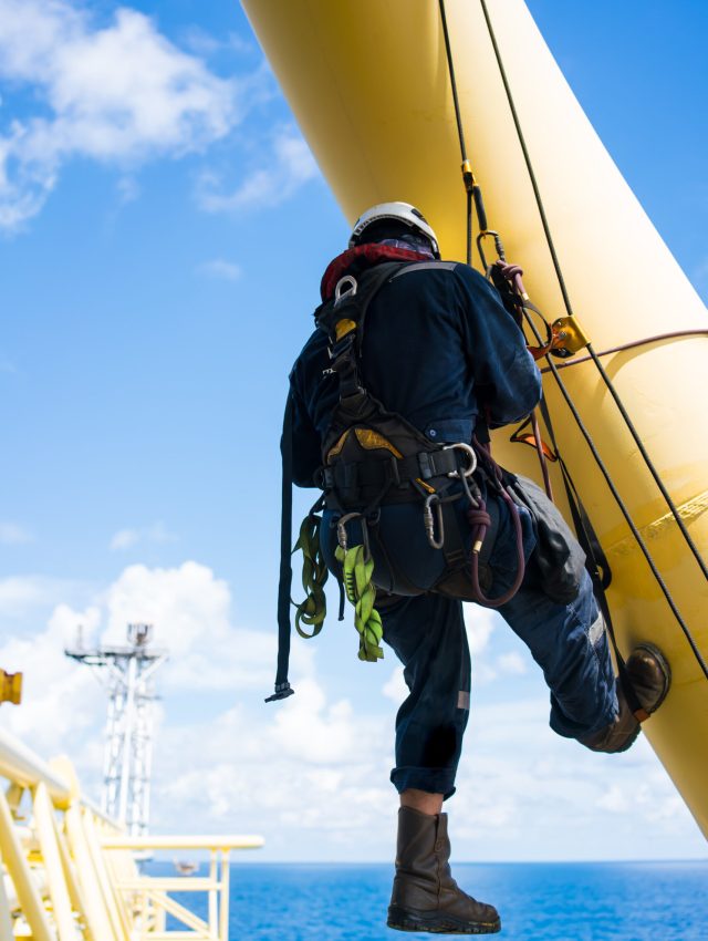 pipe inspectors in the petrochemical industry by rappelling for inspection and using ultrasonic instruments.